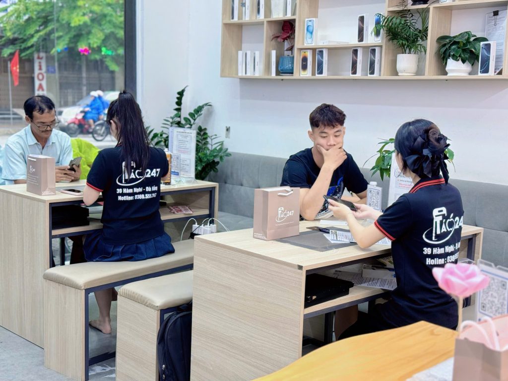 Nhân viên Táo 247 Đà Nẵng đang hỗ trợ khách hàng nhận iPhone mới mua tại cửa hàng